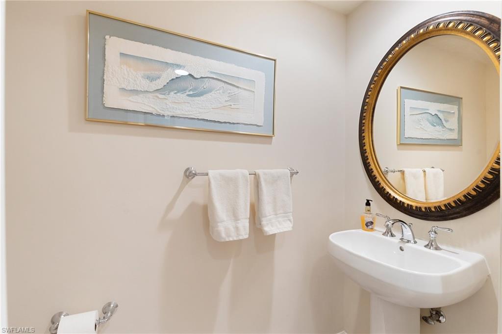 1065 Borghese Lane, Unit 203 Naples, FL 34114 - Photo 13 of 24 a bathroom with a sink and mirror