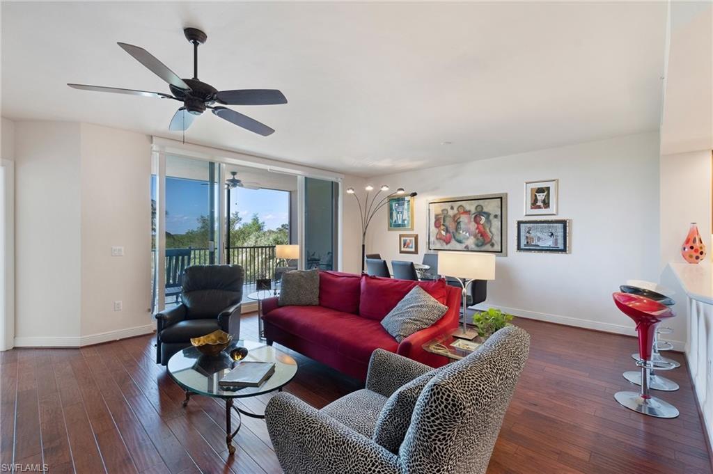 1065 Borghese Lane, Unit 203 Naples, FL 34114 - Photo 4 of 24 a living room with furniture a rug and a window