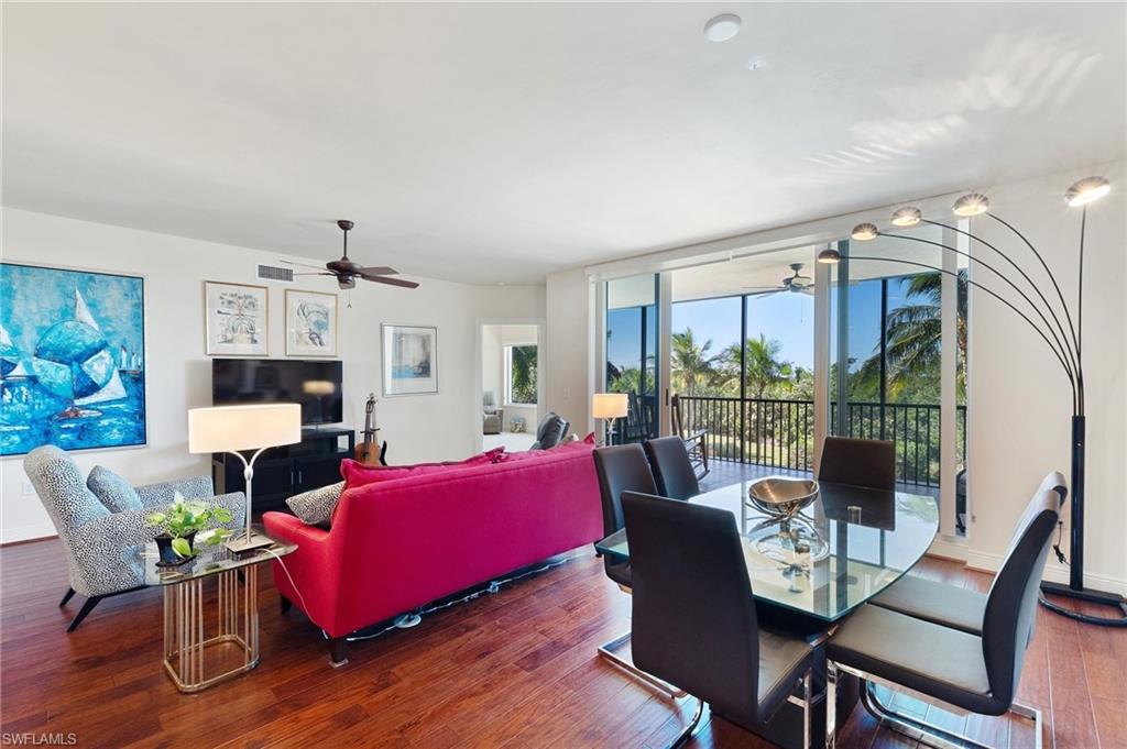 1065 Borghese Lane, Unit 203 Naples, FL 34114 - Photo 5 of 24 a living room with furniture fireplace and a large window
