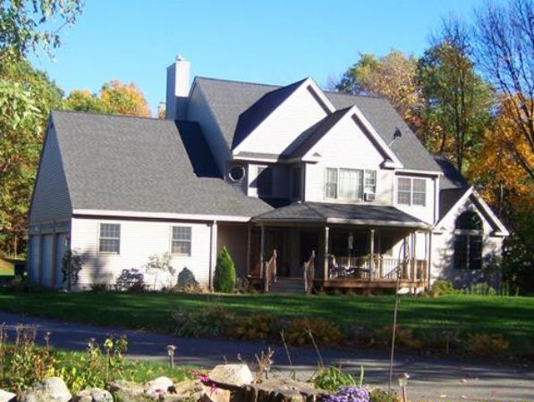 a front view of a house with garden