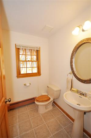 120 Stow Road Boxborough, MA 01719 - Photo 13 of 30 a bathroom with a sink a toilet and a mirror