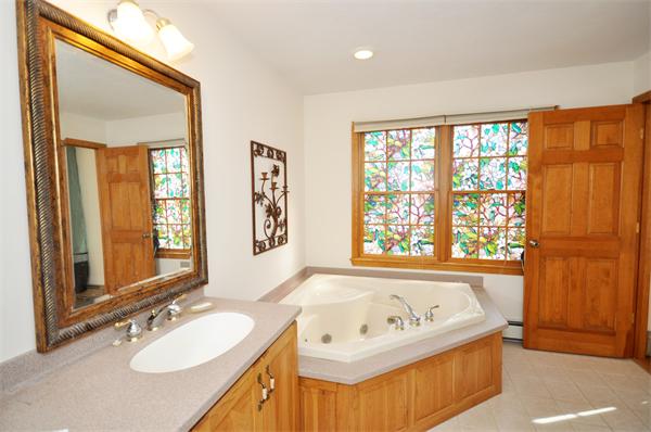 120 Stow Road Boxborough, MA 01719 - Photo 16 of 30 a bathroom with a tub sink and mirror