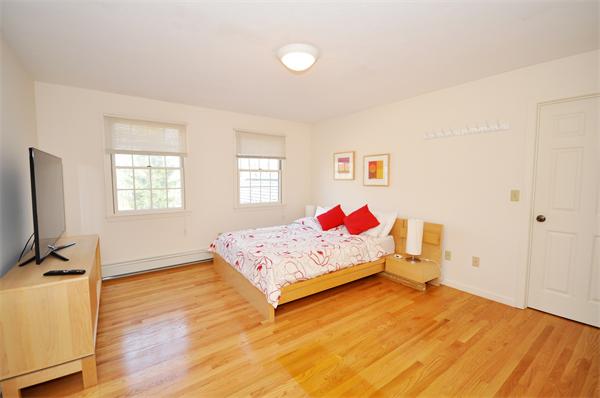 120 Stow Road Boxborough, MA 01719 - Photo 18 of 30 a bedroom with a bed and wooden floor