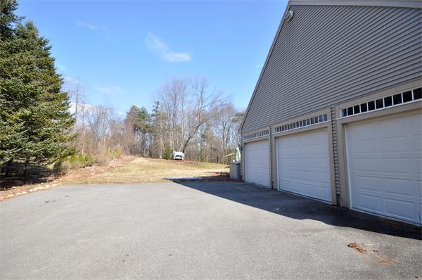 120 Stow Road Boxborough, MA 01719 - Photo 26 of 30 a view of a house with a yard and garage