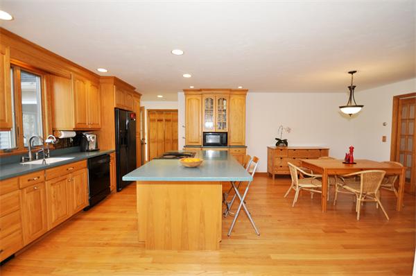 120 Stow Road Boxborough, MA 01719 - Photo 6 of 30 a dining hall with stainless steel appliances granite countertop a sink a stove and white cabinets