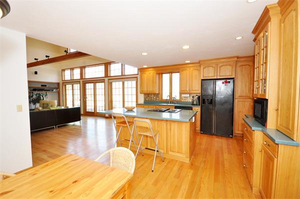 120 Stow Road Boxborough, MA 01719 - Photo 7 of 30 a kitchen with stainless steel appliances granite countertop a refrigerator a stove and a wooden floor