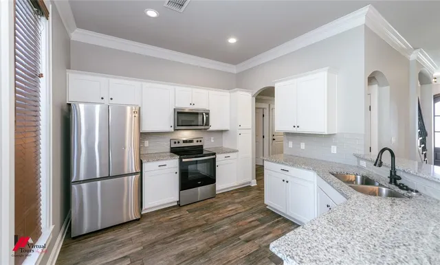 a kitchen with a refrigerator stove and sink