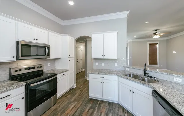 a kitchen with a sink stove and microwave