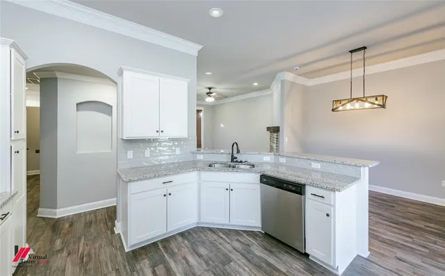 a spacious bathroom with a granite countertop sink a mirror and a shower