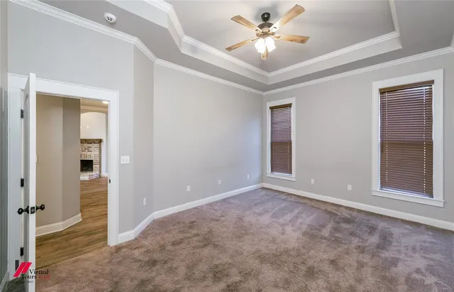 an empty room with closet and a ceiling fan