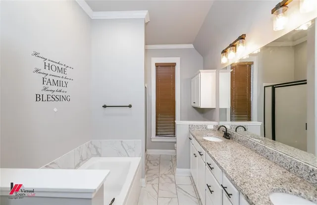 a spacious bathroom with a granite countertop sink and a bathtub