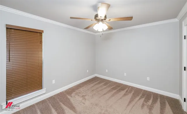a view of a room with a ceiling fan