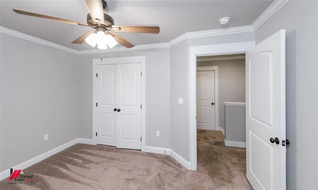 a view of a room with a chandelier fan and closet