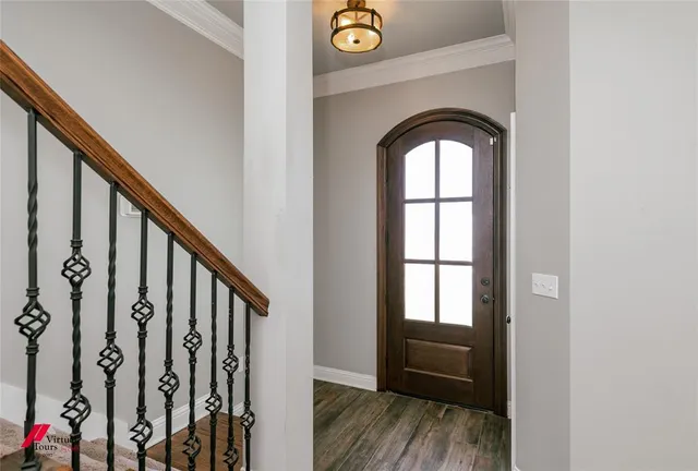 a view of front door with wooden floor and stairs