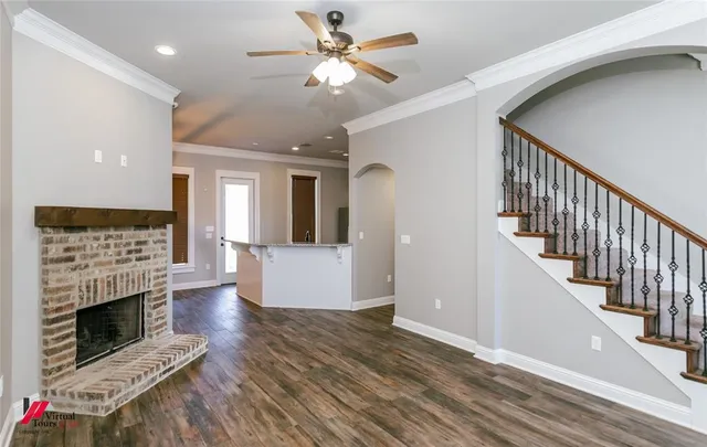 a view of a livingroom with fireplace furniture and floor to ceiling window