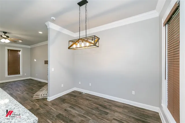a view of a room with wooden floor and chandelier