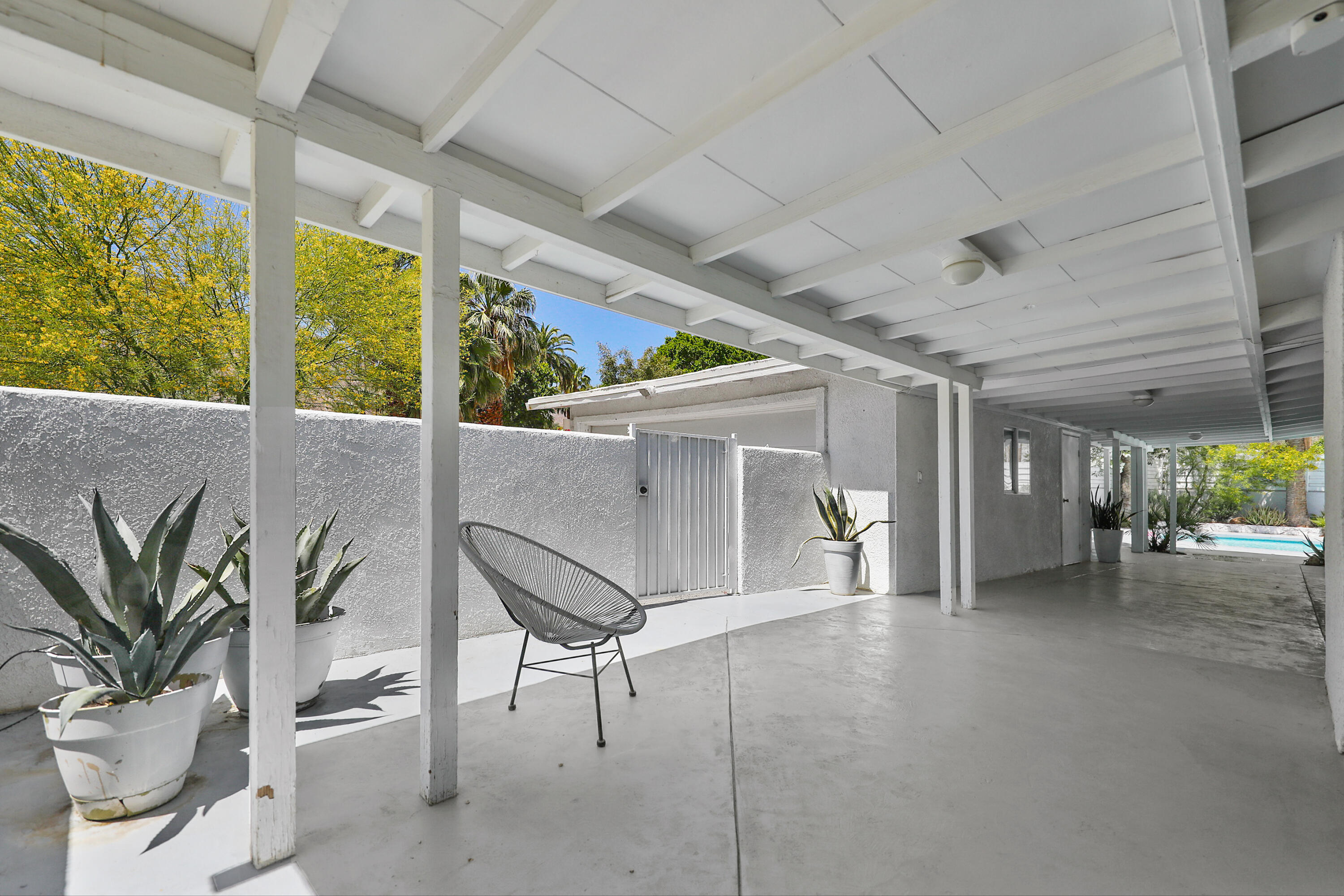 71767 Tunis Road Rancho Mirage, CA 92270 - Photo 18 of 30 a view of a porch with chairs and potted plants