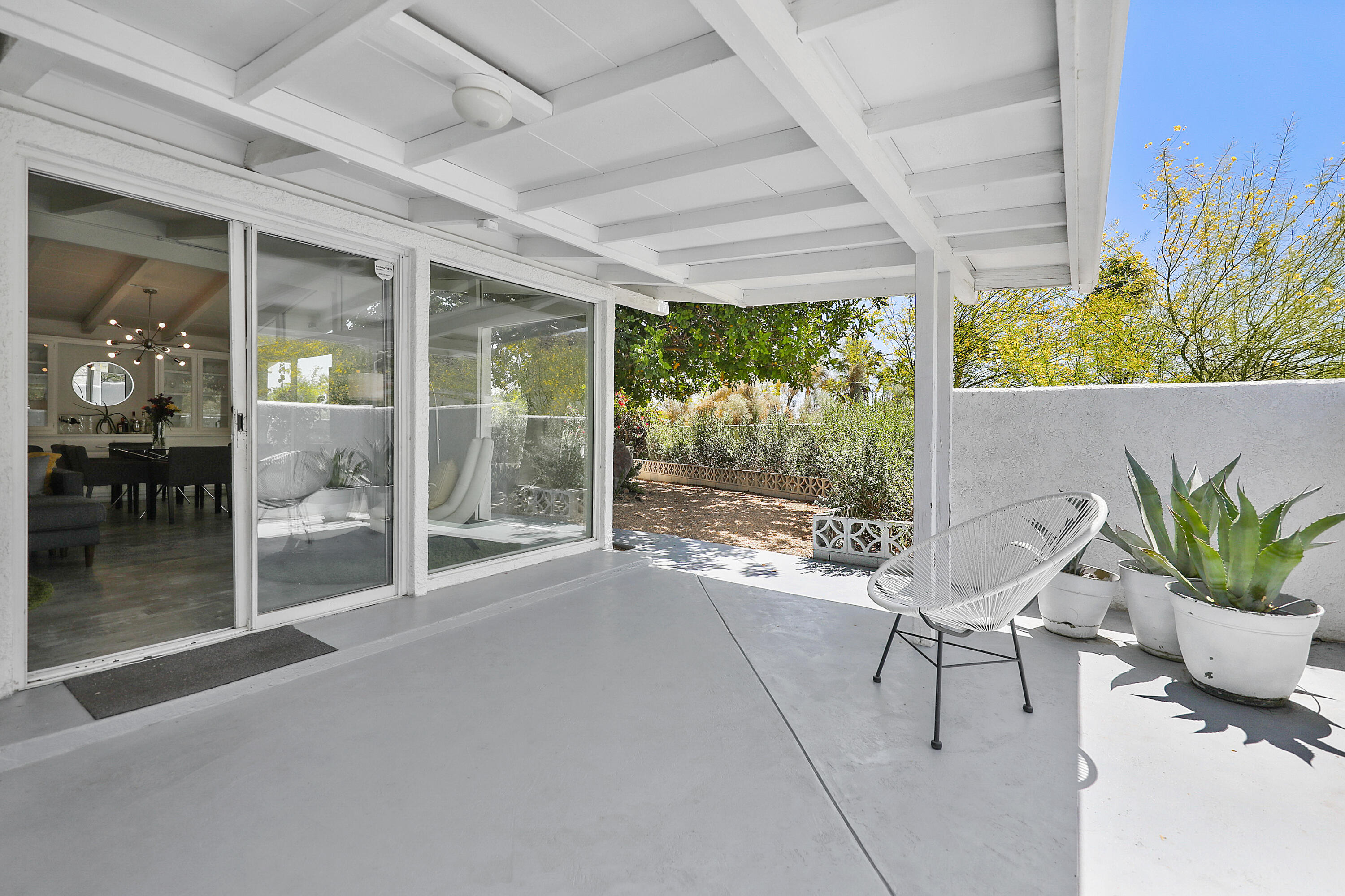 71767 Tunis Road Rancho Mirage, CA 92270 - Photo 19 of 30 a view of a porch with chairs and potted plants
