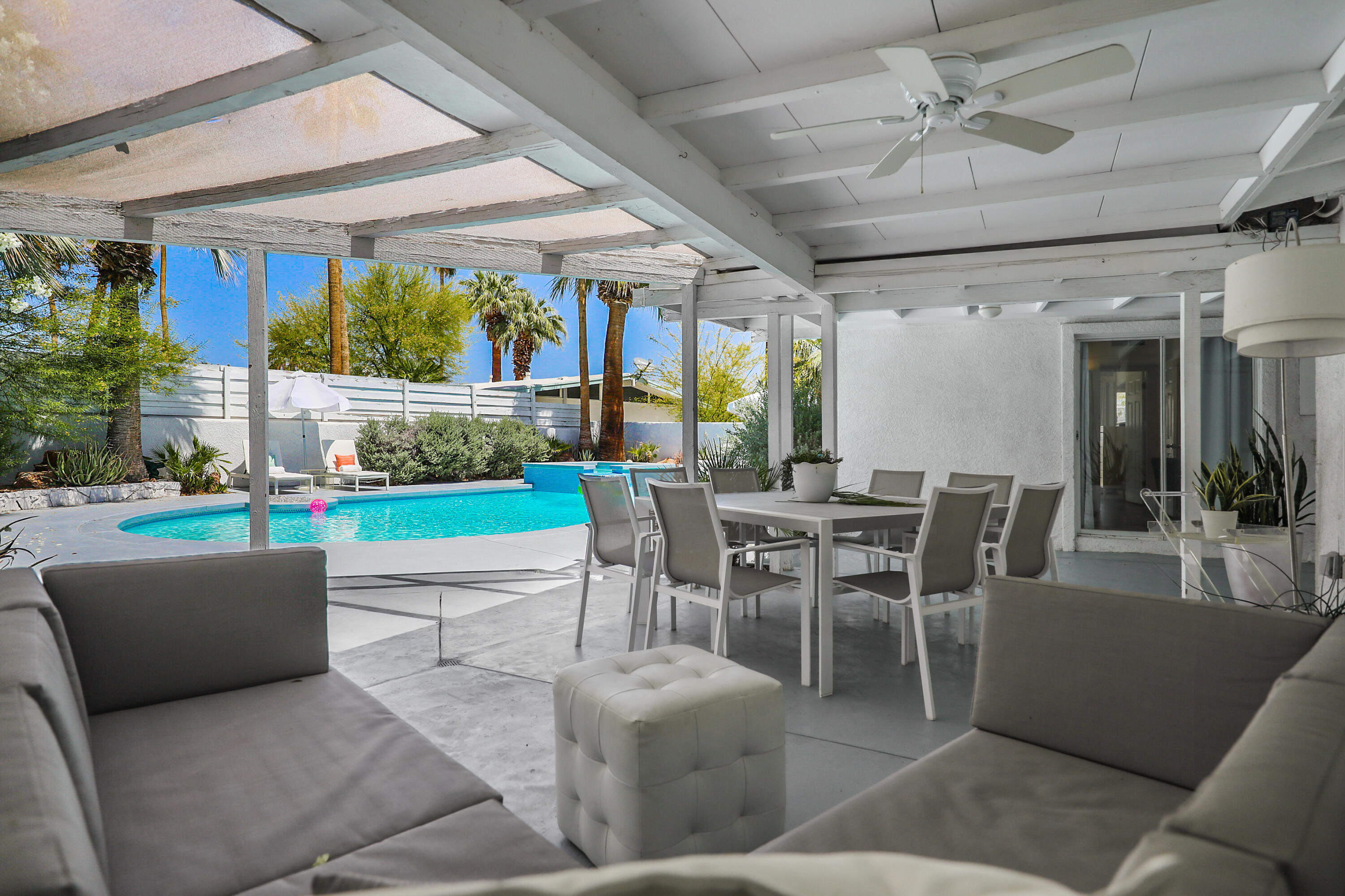 71767 Tunis Road Rancho Mirage, CA 92270 - Photo 22 of 30 a dining room with a table chairs and a floor to ceiling window