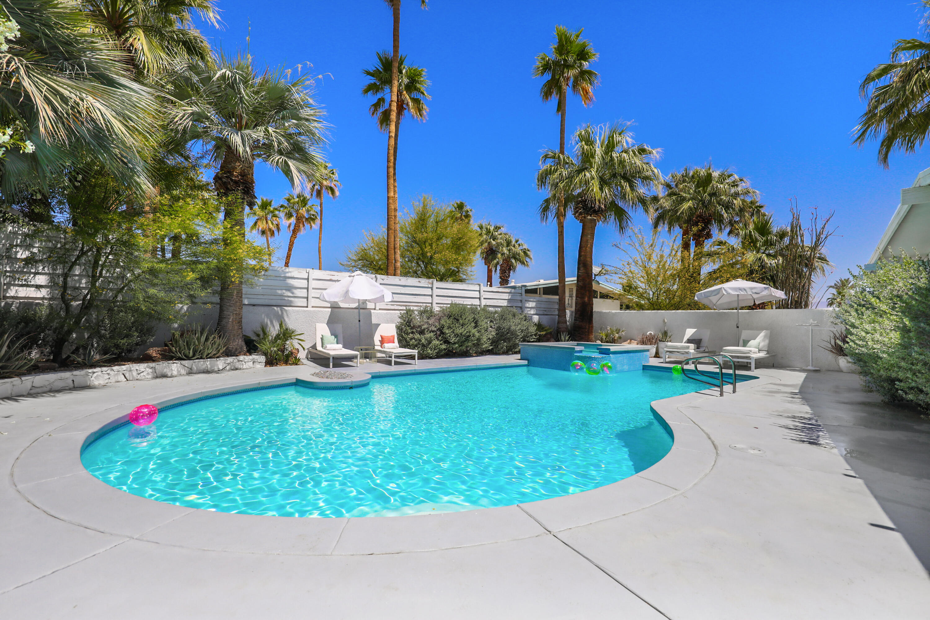 71767 Tunis Road Rancho Mirage, CA 92270 - Photo 23 of 30 a view of a swimming pool with a garden