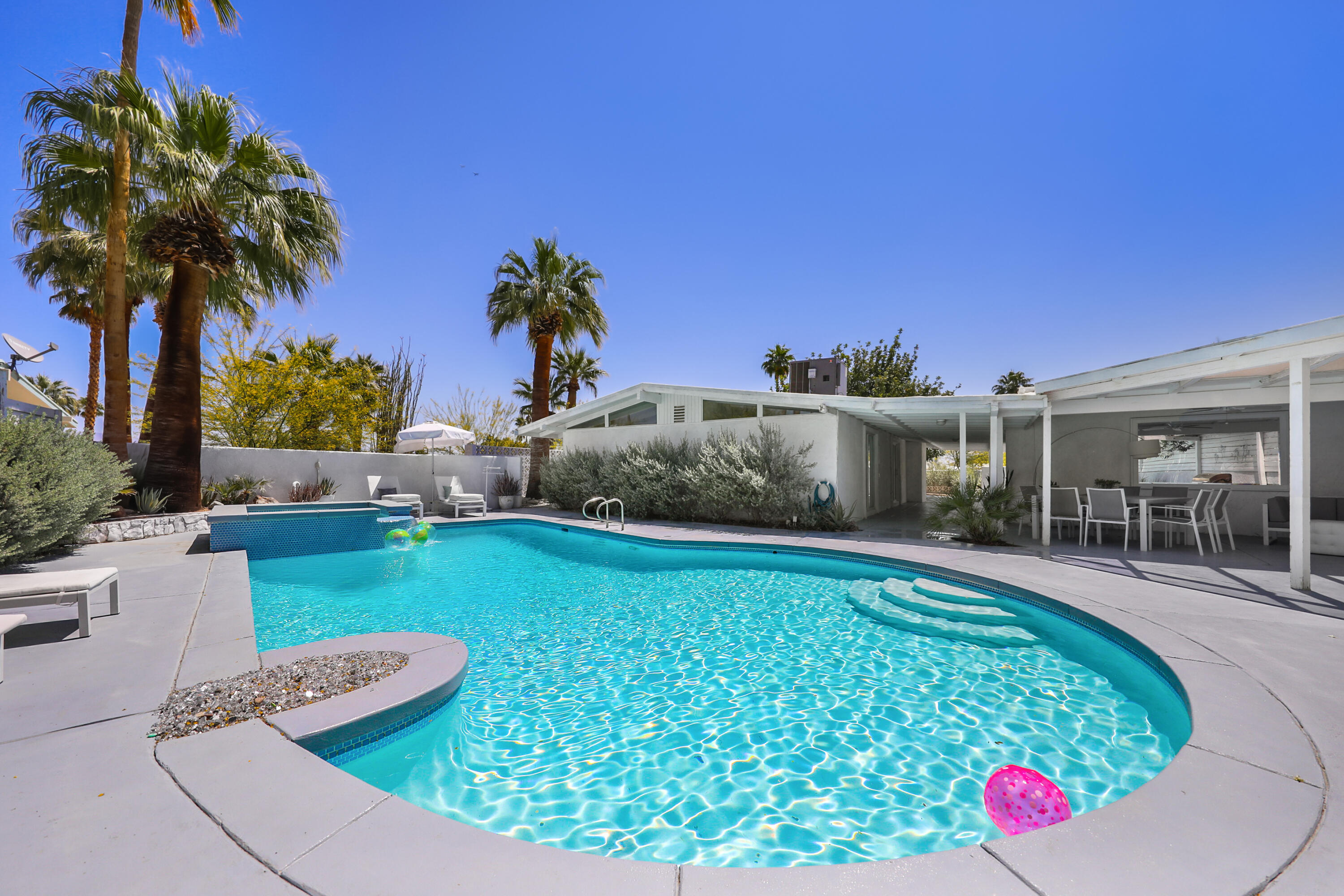 71767 Tunis Road Rancho Mirage, CA 92270 - Photo 24 of 30 a view of a house with a swimming pool and a yard