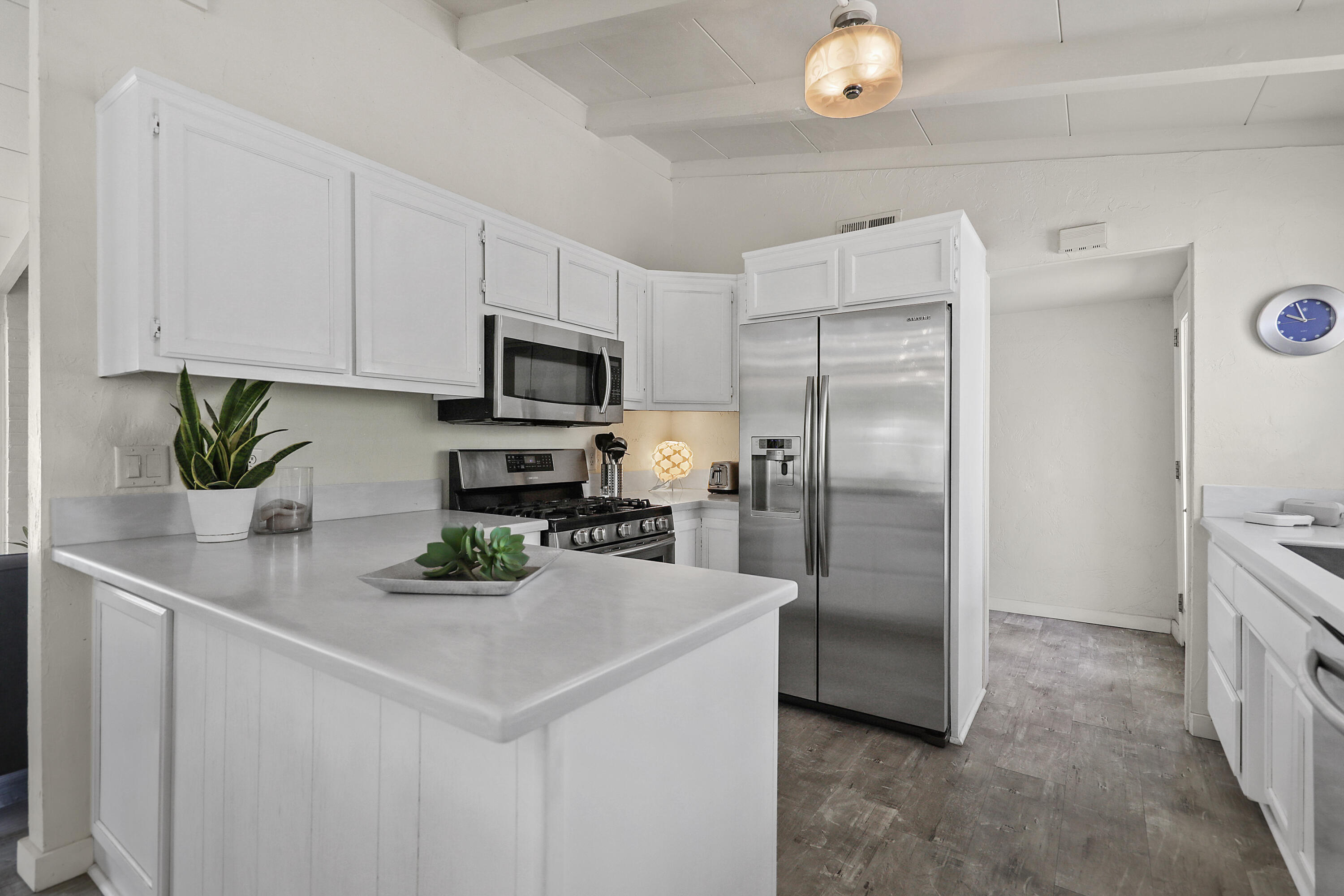 71767 Tunis Road Rancho Mirage, CA 92270 - Photo 9 of 30 a kitchen with stainless steel appliances a refrigerator sink and white cabinets