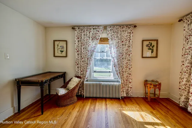 a view of a lush green field with a lake in the background
