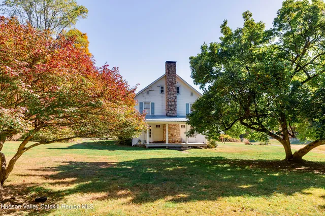 a view of a lush green hillside and a houses