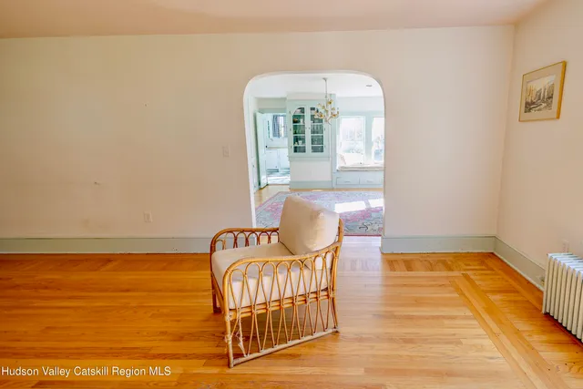 view of an empty room with a window and wooden floor