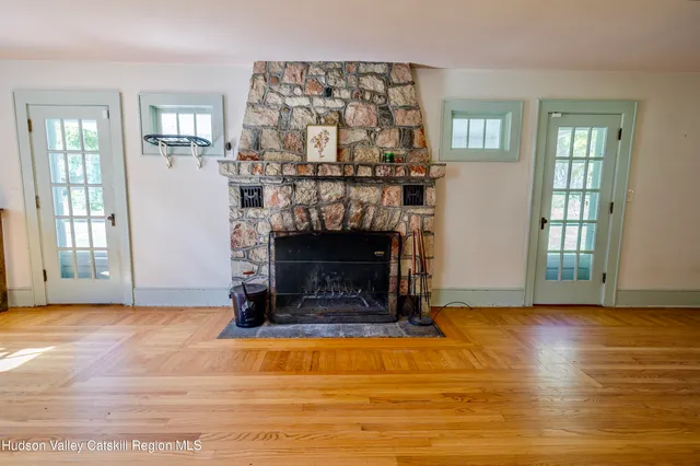 a view of a bedroom with wooden floor and cabinet