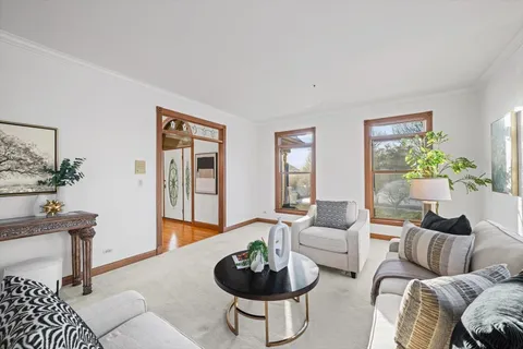 a dining room with furniture a rug and a chandelier