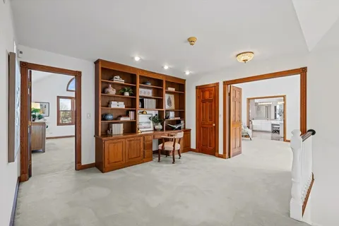 a bathroom with a large tub a sink and large windows