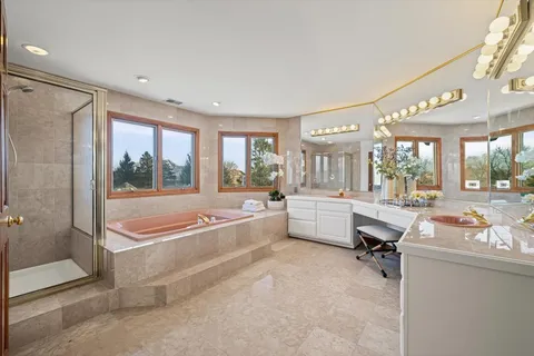 a bathroom with a granite countertop sink a toilet and shower
