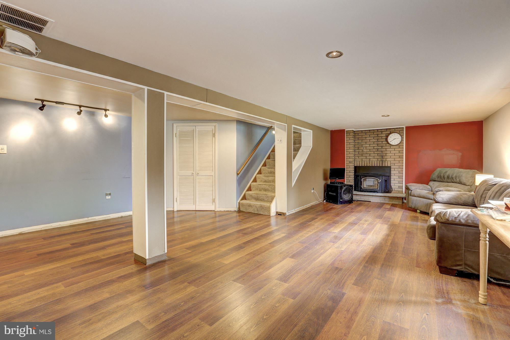7833 Belgaro Road Laurel, MD 20723 - Photo 21 of 32 Lower level rec room has wood burning stove
