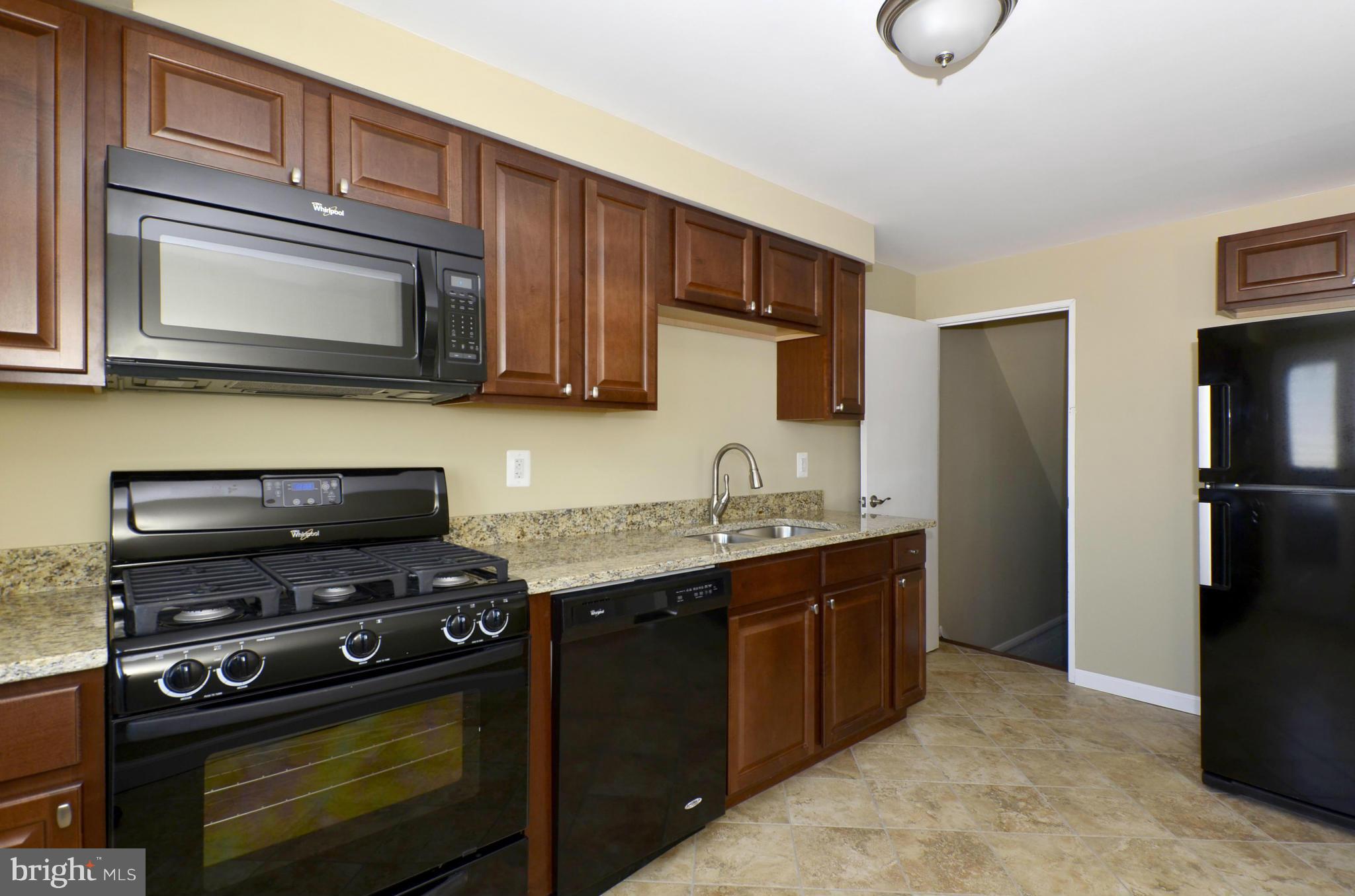 8058 Stratman Road Baltimore, MD 21222 - Photo 1 of 30 a kitchen with a sink stove and refrigerator