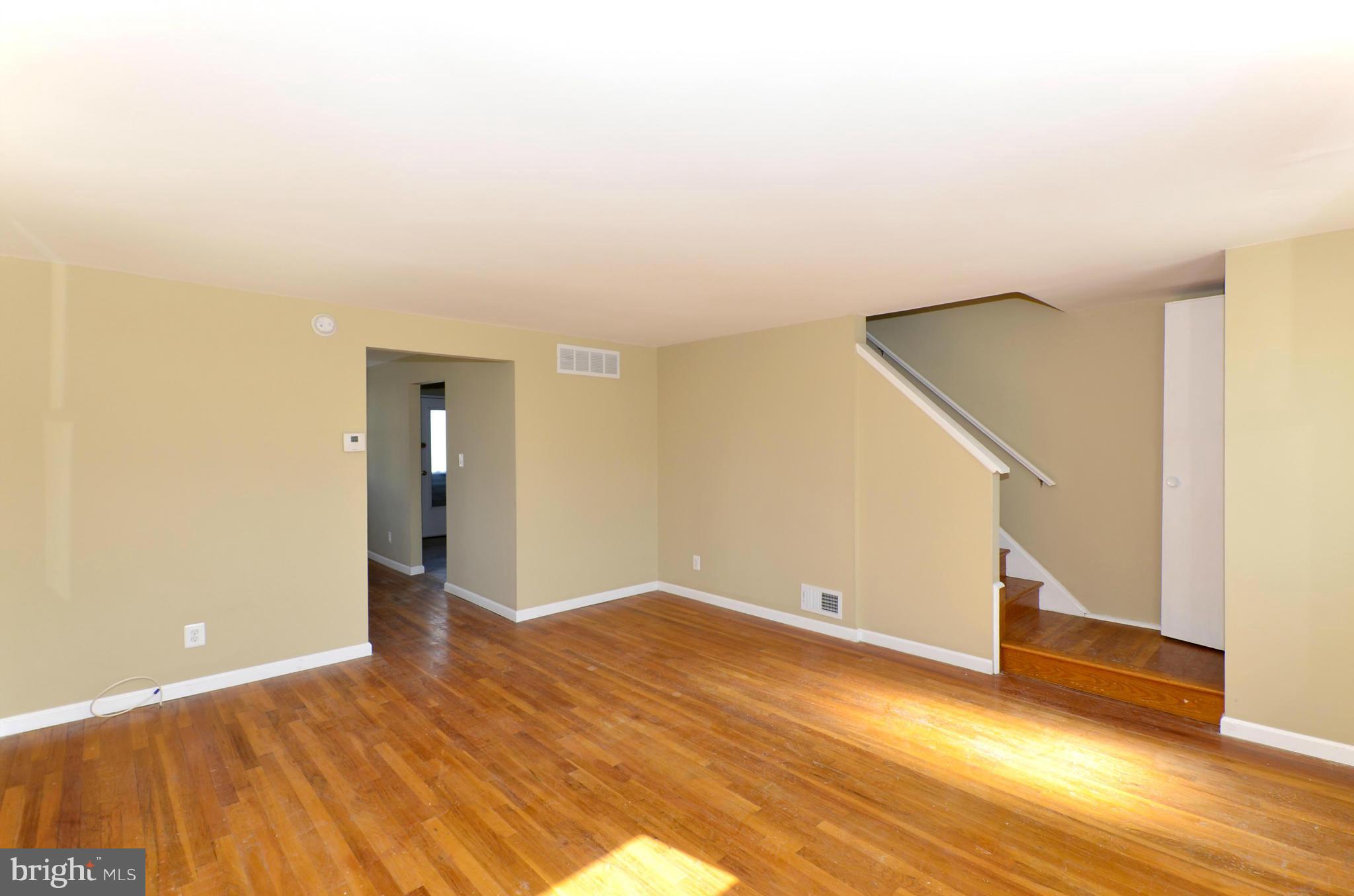 8058 Stratman Road Baltimore, MD 21222 - Photo 11 of 30 a view of an empty room with wooden floor