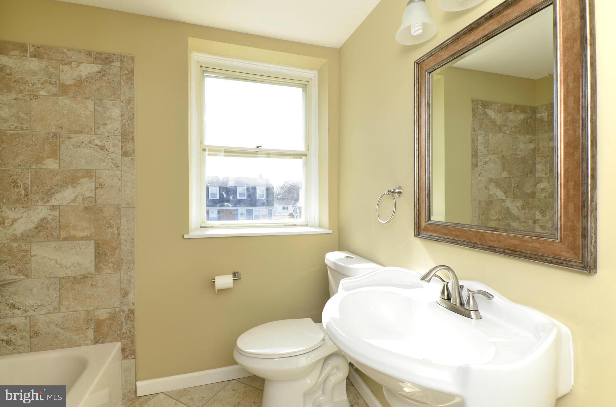 8058 Stratman Road Baltimore, MD 21222 - Photo 15 of 30 a bathroom with a sink a toilet and shower