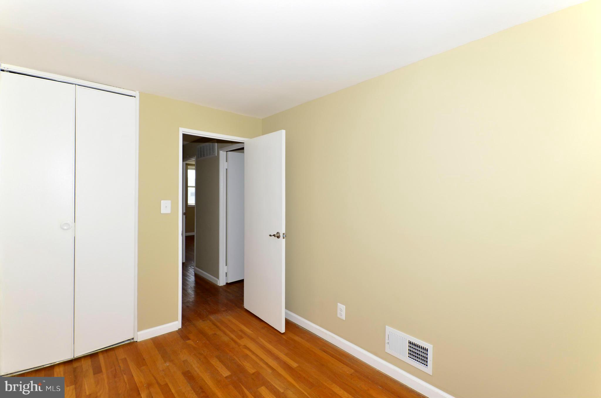 8058 Stratman Road Baltimore, MD 21222 - Photo 21 of 30 a view of an empty room with wooden floor