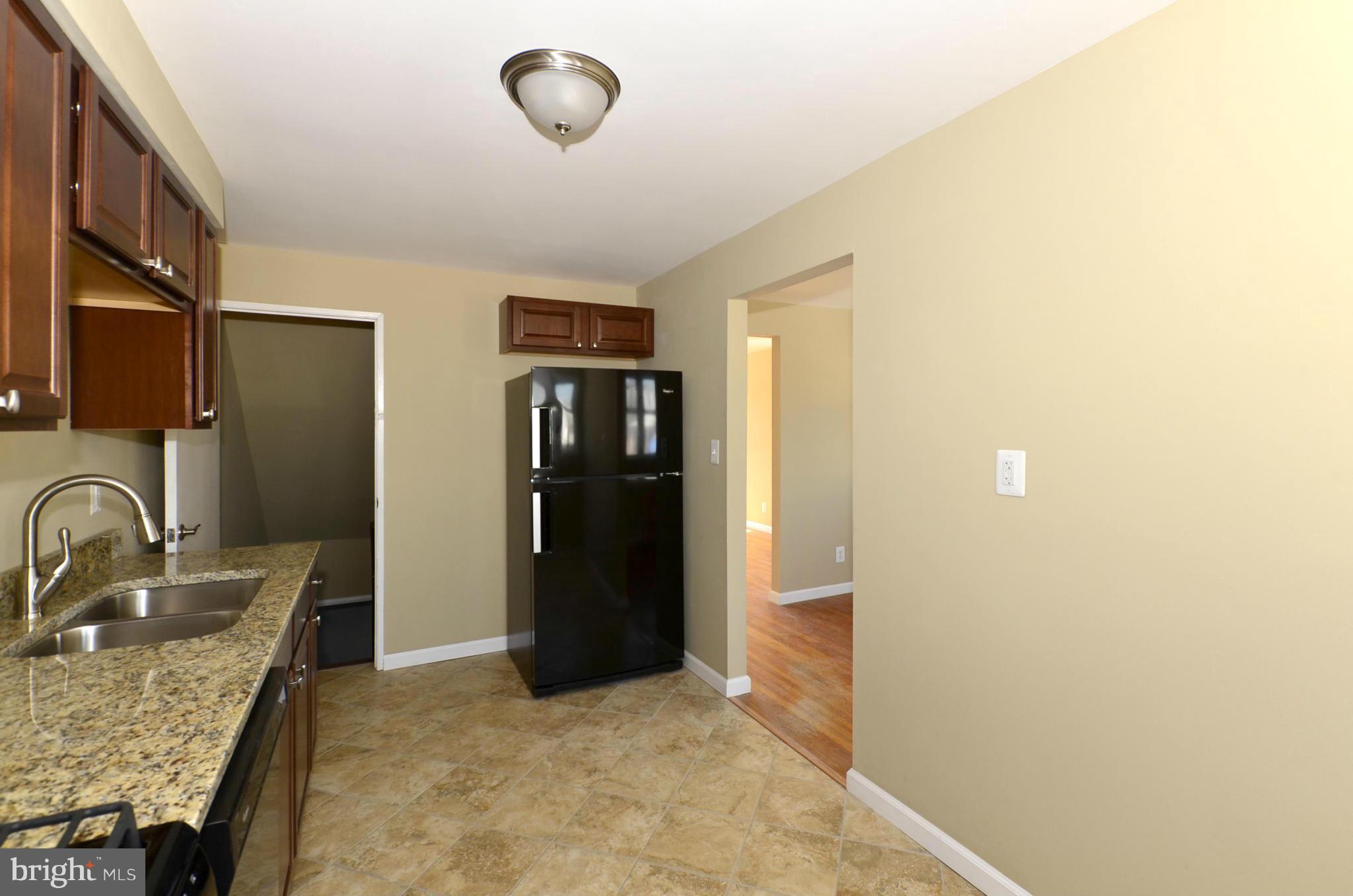 8058 Stratman Road Baltimore, MD 21222 - Photo 5 of 30 a bathroom with a granite countertop sink and a mirror