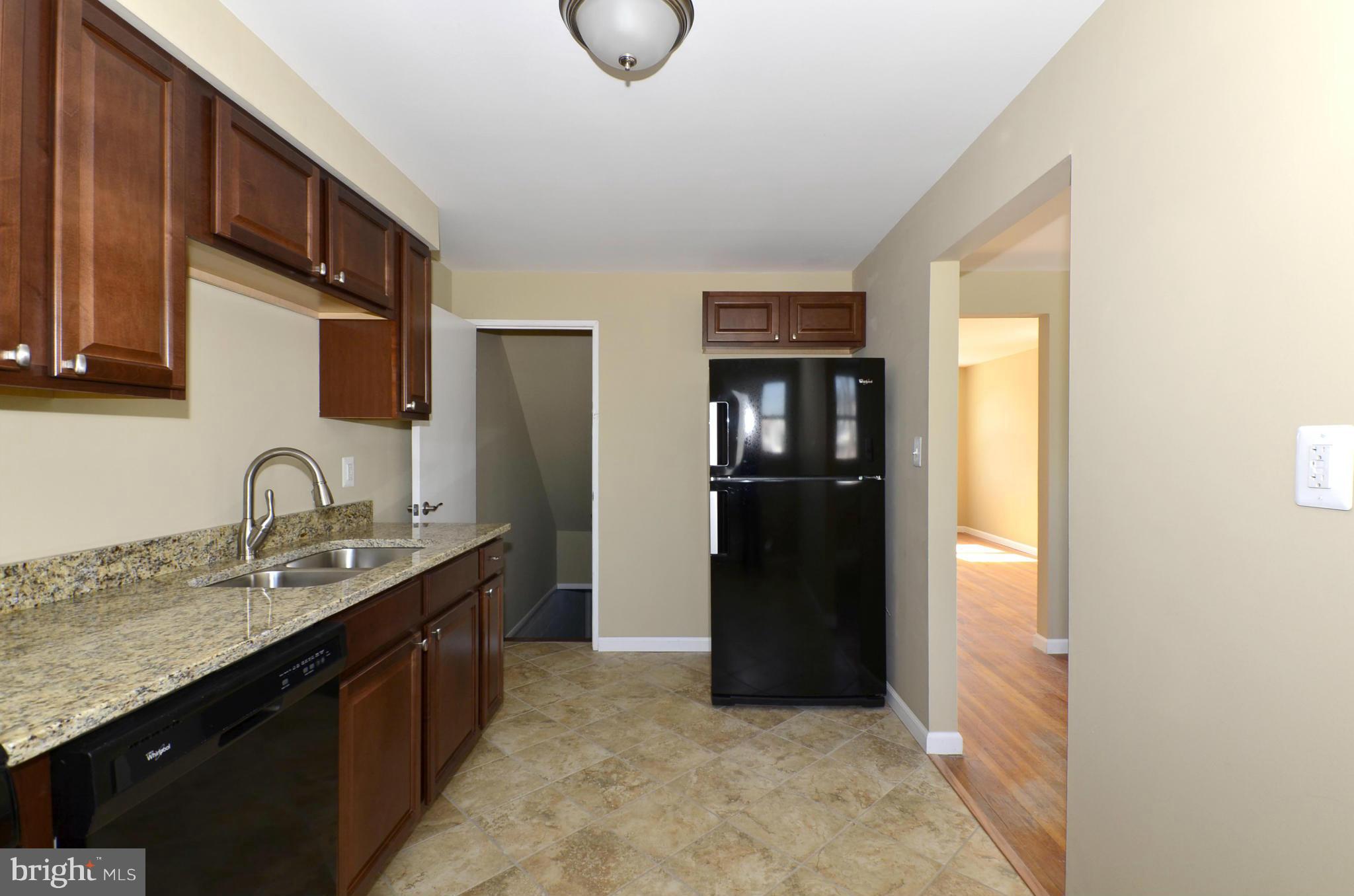 8058 Stratman Road Baltimore, MD 21222 - Photo 6 of 30 a kitchen with stainless steel appliances granite countertop a refrigerator and a sink