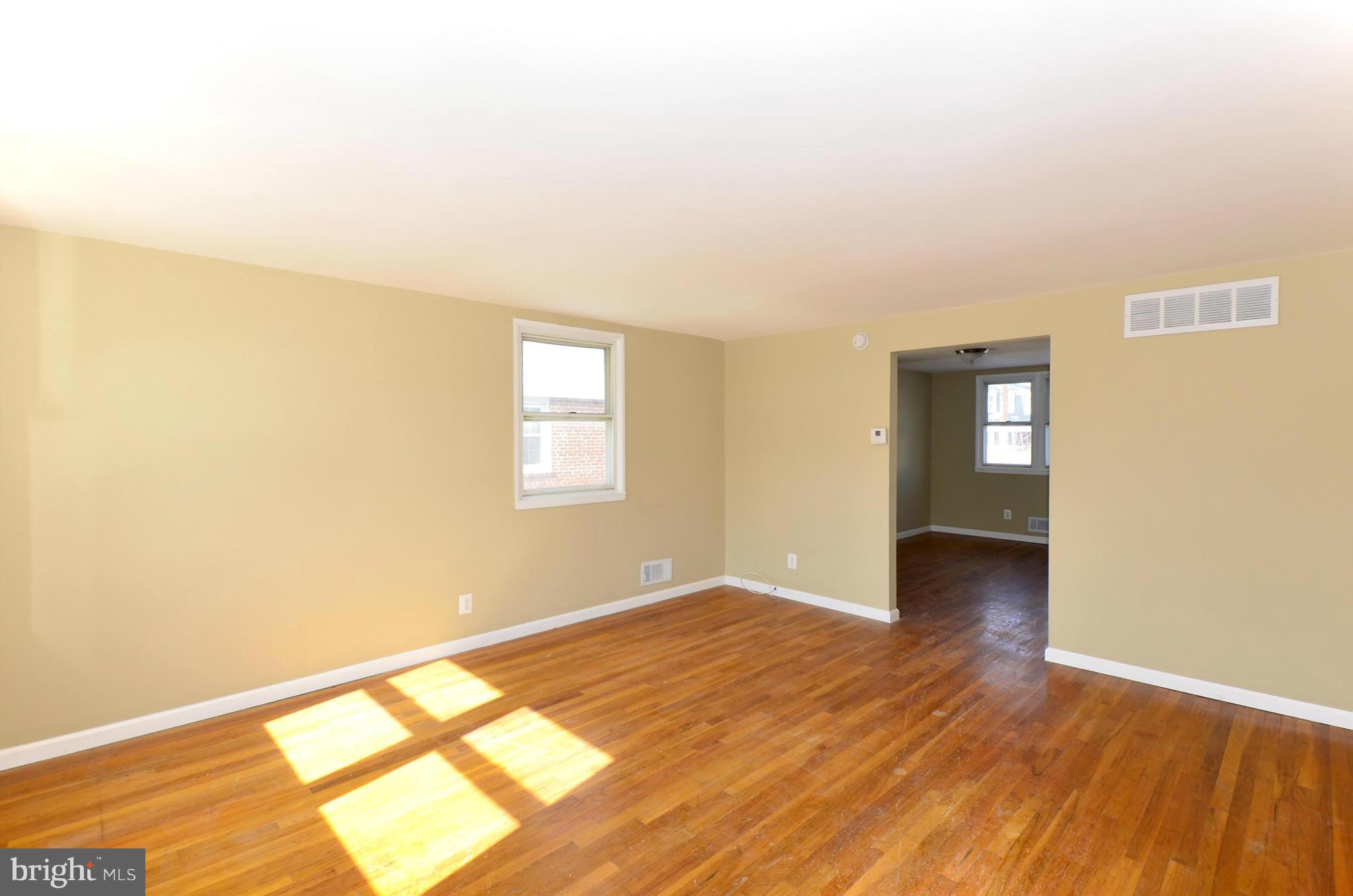 8058 Stratman Road Baltimore, MD 21222 - Photo 10 of 30 a view of empty room with wooden floor and fan