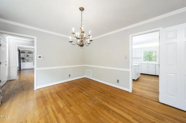 a bedroom with a large bed and a potted plant