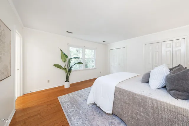 a spacious bedroom with a bed and window