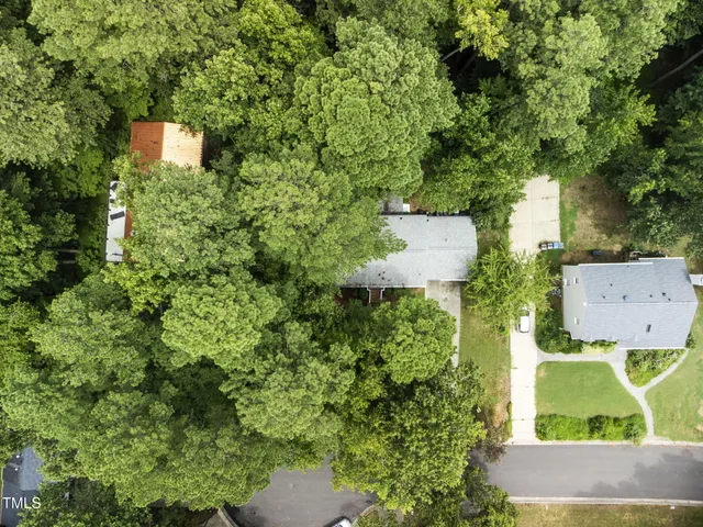 an aerial view of a house with a yard