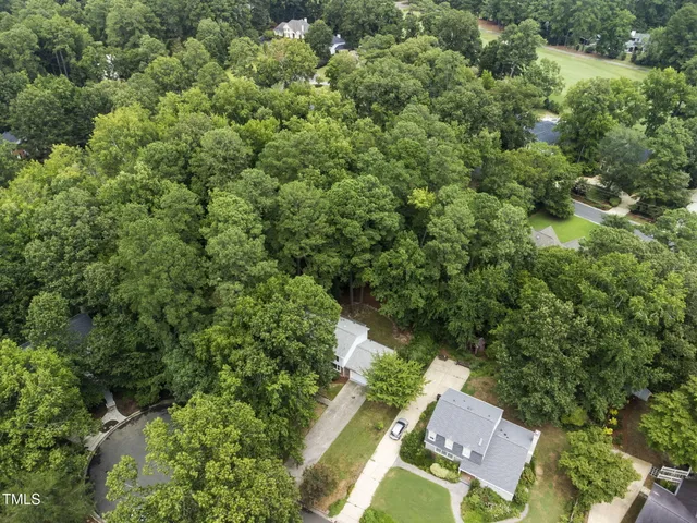 an aerial view of a swimming pool with outdoor seating