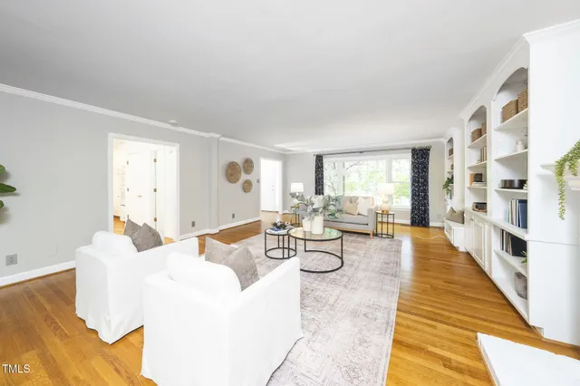 a large white kitchen with wooden floor