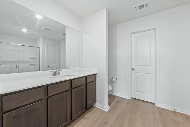 a bathroom with a double vanity sink and mirror