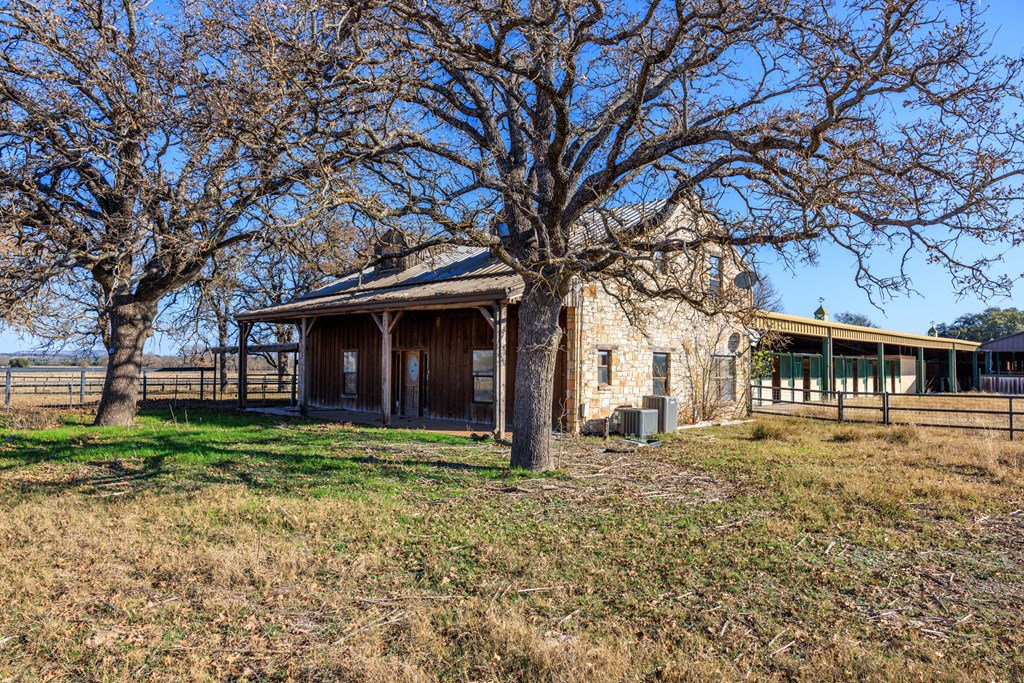 485 Fulton Ranch Road Stonewall, TX 78671 - Photo 18 of 22 a front view of a house with a yard