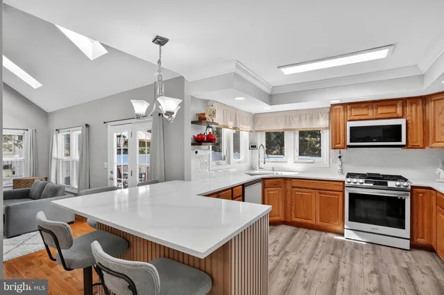 a kitchen with stainless steel appliances granite countertop a stove refrigerator and microwave