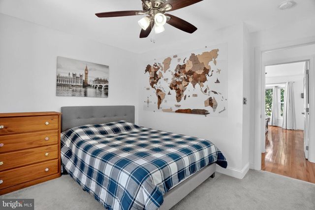 a bedroom with a bed and painting on the wall